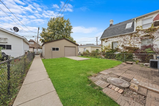 view of yard featuring cooling unit, a garage, an outbuilding, and a patio area