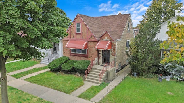 tudor home featuring a front yard