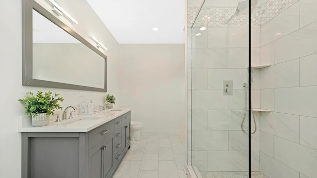 bathroom featuring tiled shower, vanity, and toilet