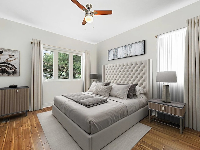 bedroom with ceiling fan and wood-type flooring