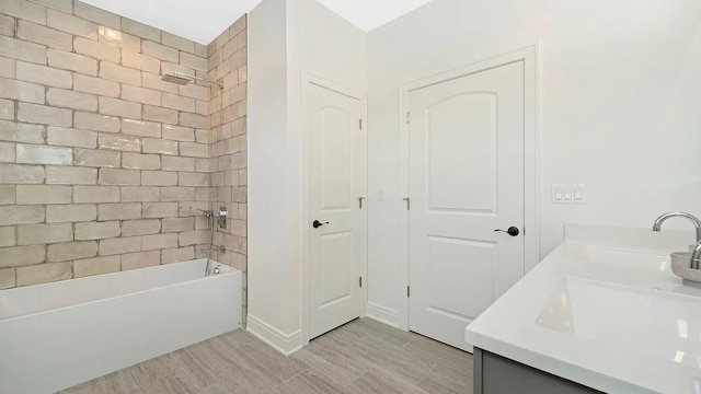 bathroom with vanity and tiled shower / bath combo