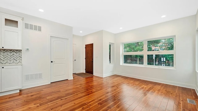 unfurnished living room with light hardwood / wood-style flooring