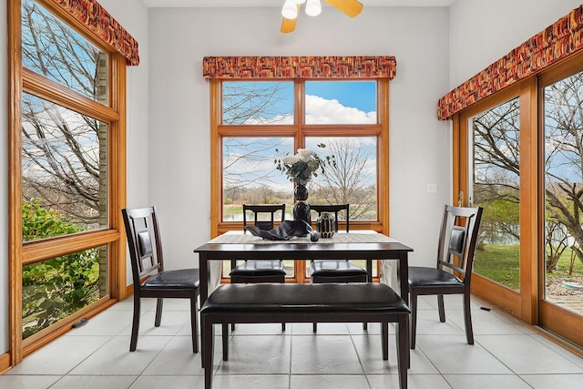 tiled dining area with ceiling fan