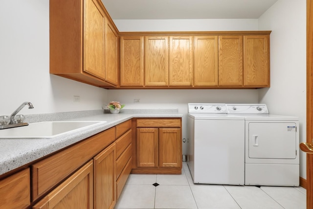 washroom featuring sink, light tile patterned floors, cabinets, and independent washer and dryer