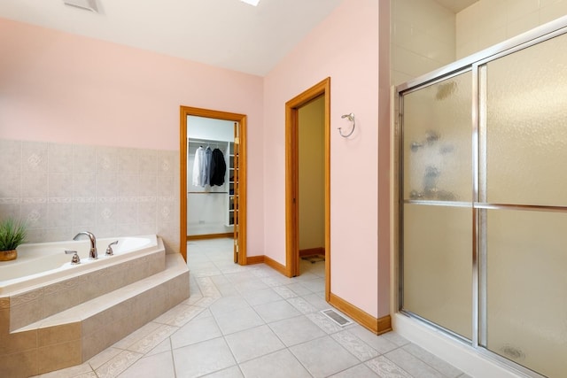 bathroom with tile patterned floors and separate shower and tub