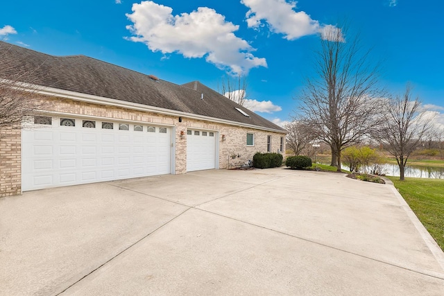 view of property exterior featuring a garage and a water view