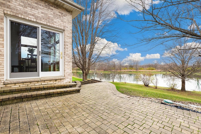 view of patio featuring a water view