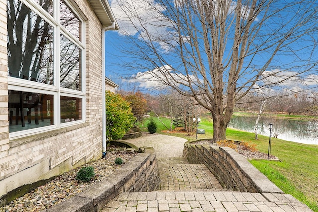 exterior space featuring a water view and a patio area