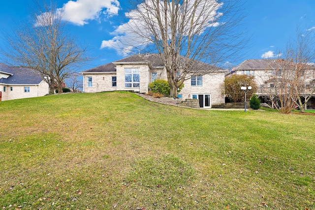 back of house with a lawn