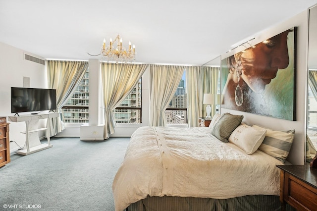 bedroom featuring carpet and a chandelier