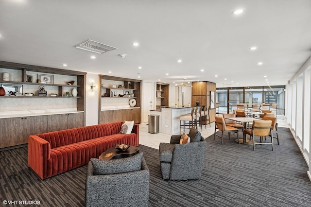 living room with dark colored carpet