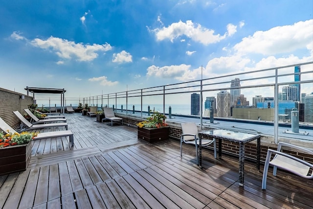 wooden terrace featuring a water view