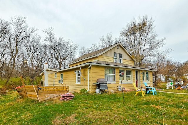 back of property featuring a yard and cooling unit