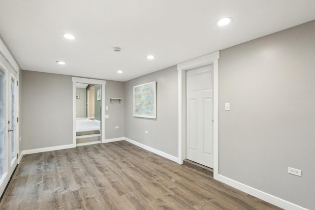 unfurnished room with hardwood / wood-style flooring