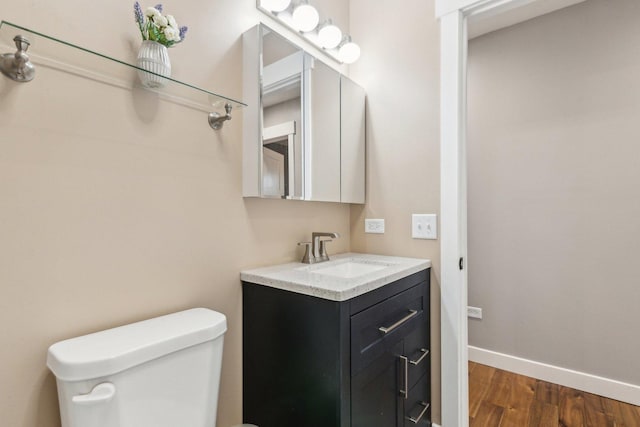 bathroom featuring hardwood / wood-style flooring, vanity, and toilet