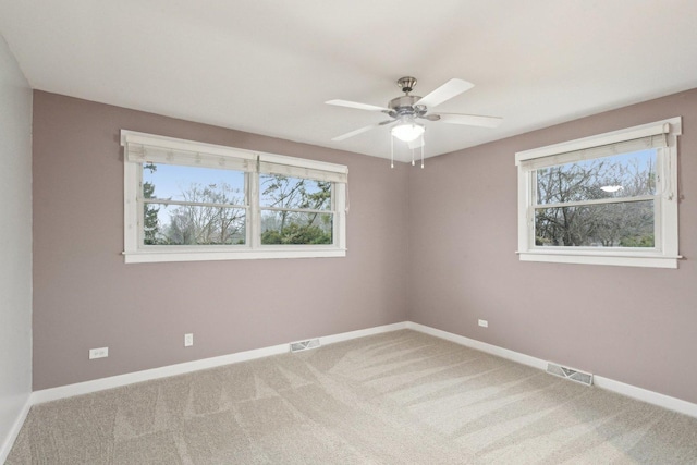 carpeted empty room featuring ceiling fan