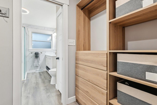 spacious closet featuring hardwood / wood-style floors