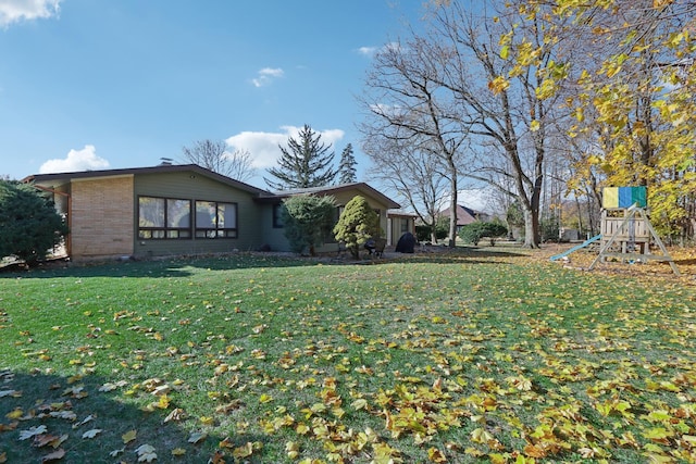 exterior space featuring a lawn and a playground