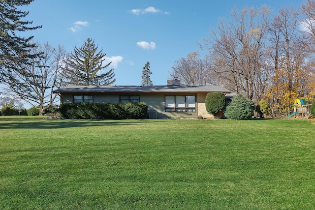 view of front of home featuring a playground and a front yard