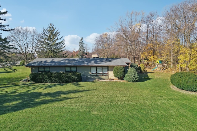 exterior space with central AC, a front yard, and a playground