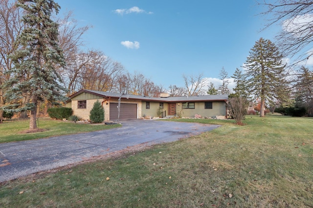 ranch-style home featuring a garage and a front yard