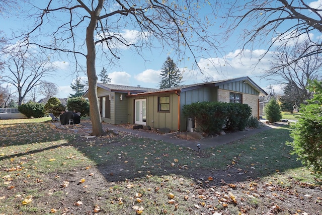 view of side of property with a yard