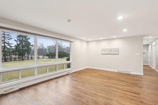 spare room featuring light hardwood / wood-style floors