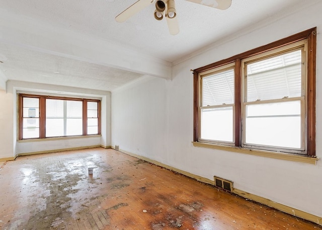 spare room featuring ceiling fan, a textured ceiling, and hardwood / wood-style flooring