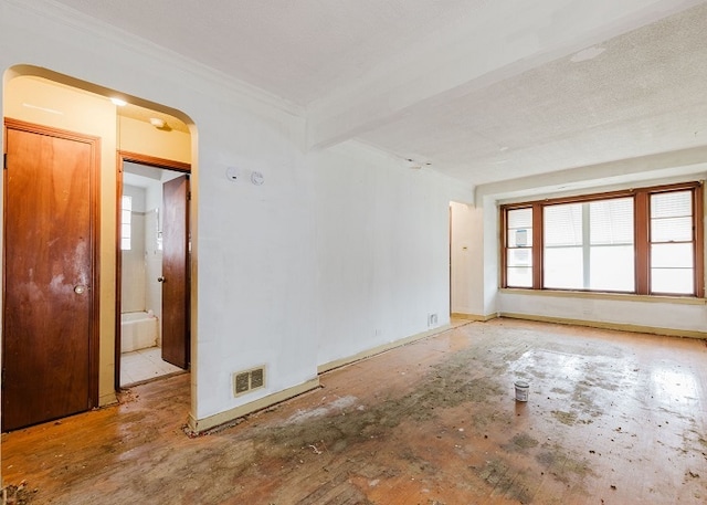 empty room featuring beamed ceiling