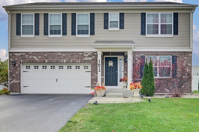 view of front facade with a front yard and a garage