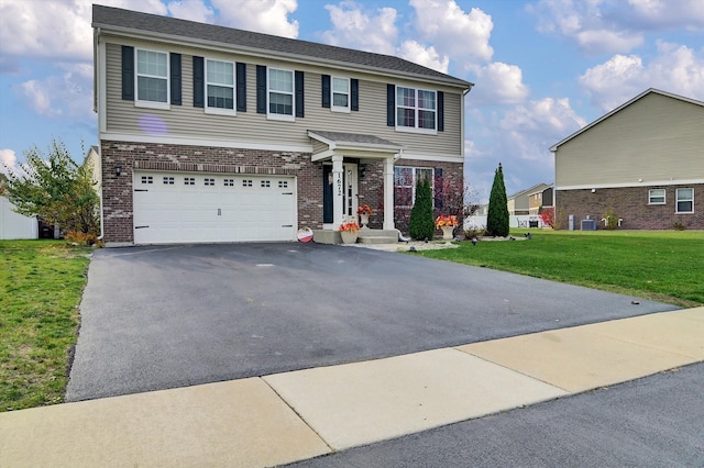 view of front of house featuring a garage, a front lawn, and central air condition unit