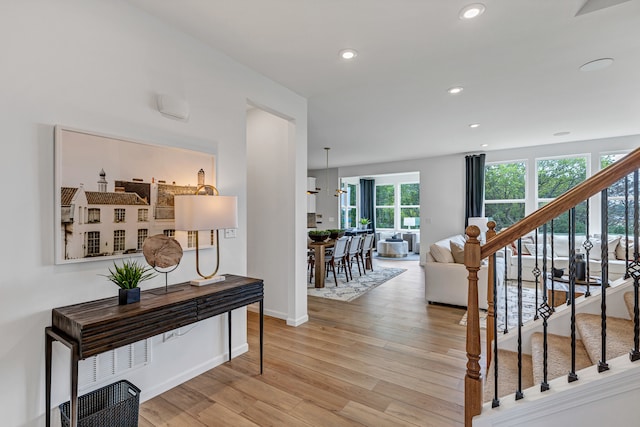 interior space featuring a notable chandelier and light wood-type flooring