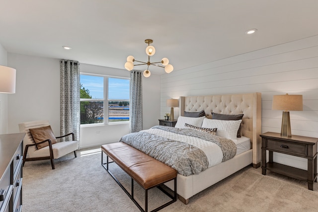 carpeted bedroom with an inviting chandelier