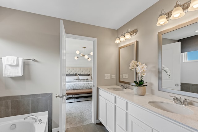 bathroom featuring tile patterned floors, a tub, and vanity