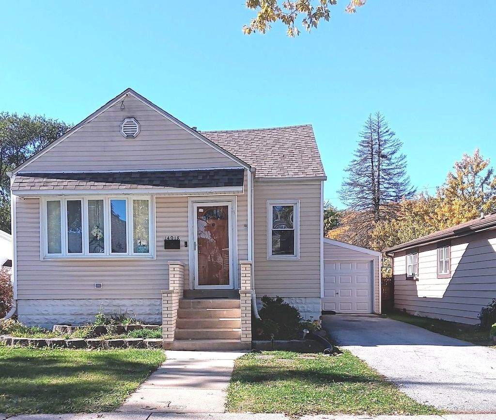 view of front of property featuring a garage and an outdoor structure