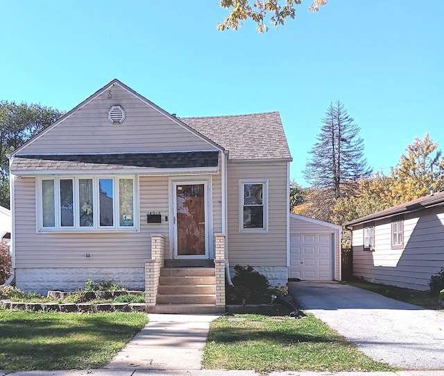 view of front of property featuring a garage and an outdoor structure