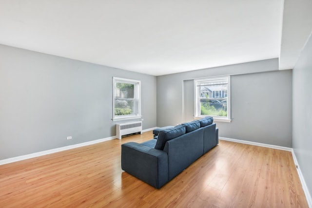 living room with radiator heating unit and light hardwood / wood-style floors