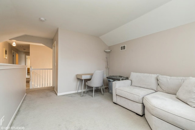 carpeted living room with vaulted ceiling