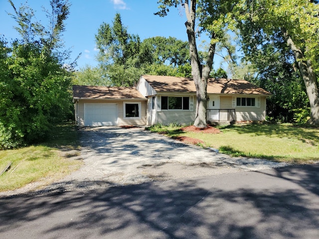 single story home featuring a garage and a front lawn