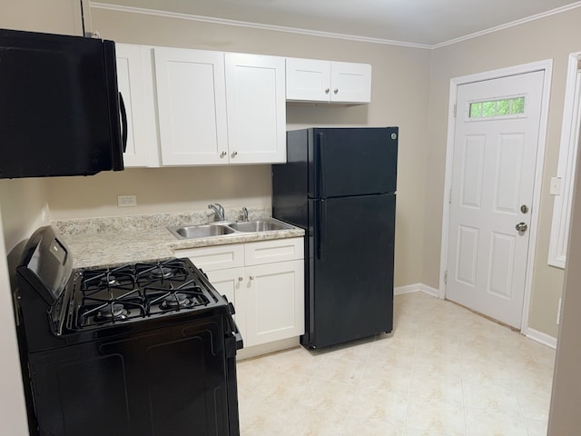 kitchen featuring light stone counters, ornamental molding, black appliances, sink, and white cabinetry