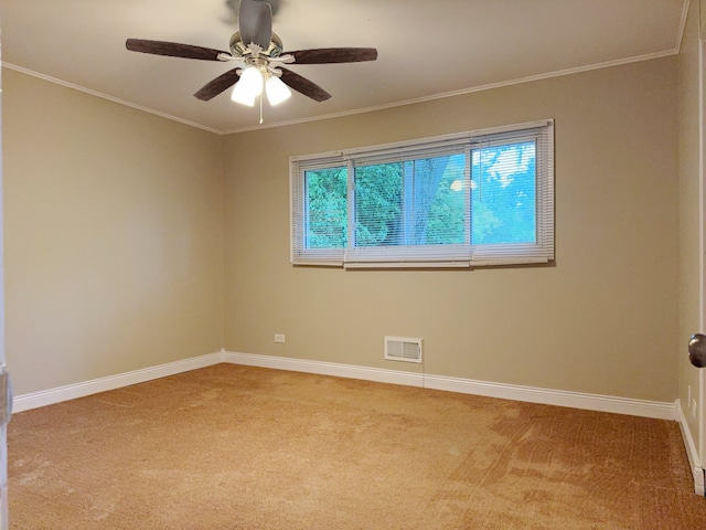 spare room with light carpet, ceiling fan, and crown molding