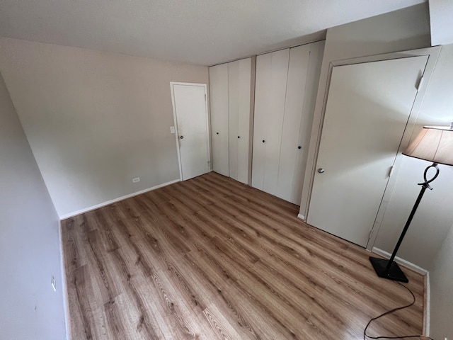 unfurnished bedroom featuring a closet and light hardwood / wood-style flooring