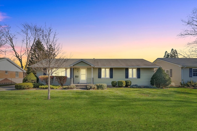 ranch-style home with a lawn