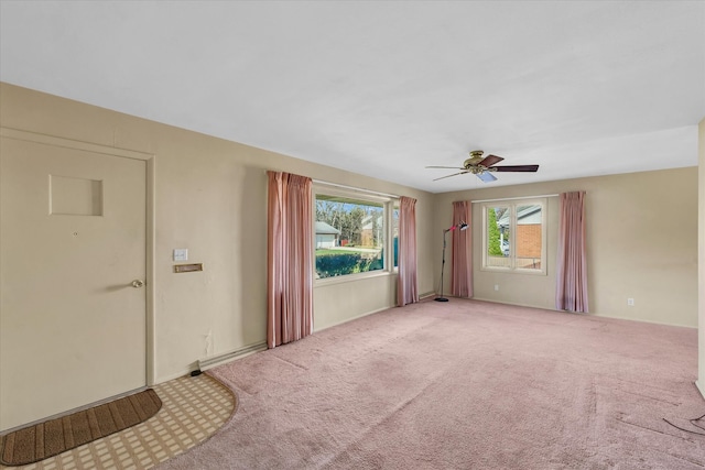 empty room featuring ceiling fan and carpet