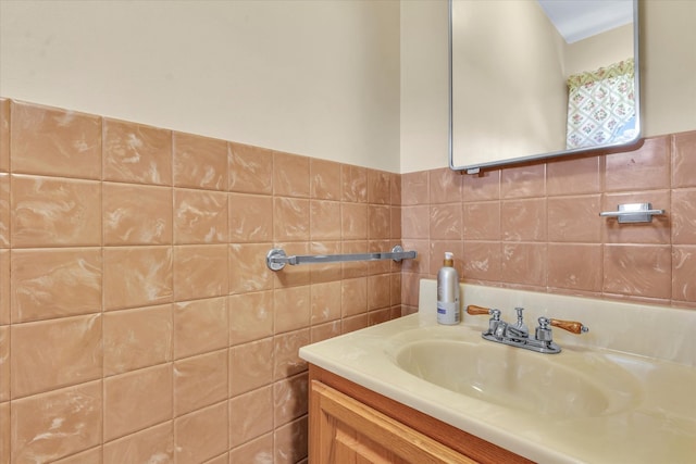 bathroom featuring vanity and tile walls