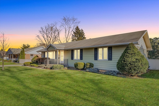 single story home with a lawn