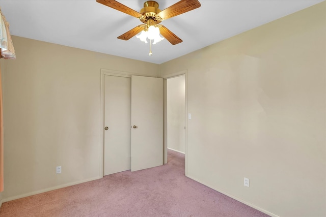 unfurnished bedroom with ceiling fan, a closet, and light colored carpet