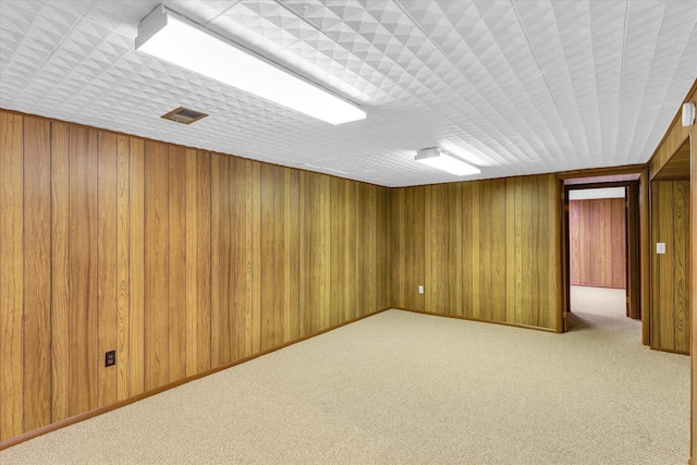 basement with wooden walls and carpet