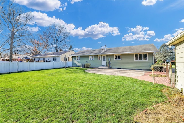 back of property with a lawn, a patio, and central AC unit