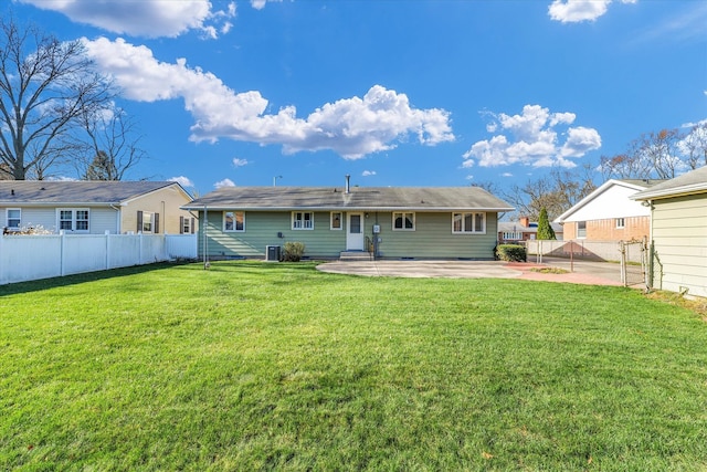 back of house with a lawn and a patio area